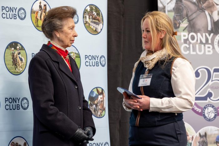 Bourne Vale Stables co-owner Anna Cooper accepts a plaque from HRH Princess Royal in recognition of over 25 years as a Pony Club Centre